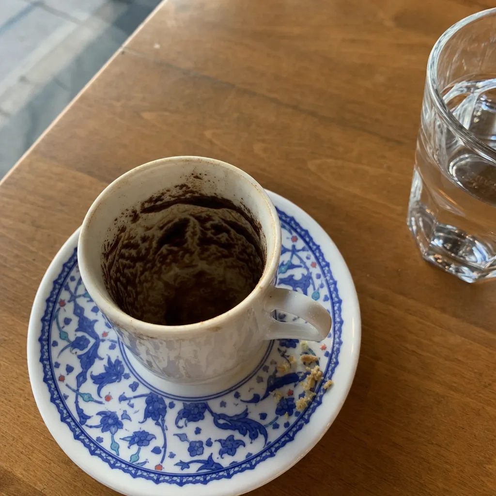 A Turkish coffee cup with grounds settled into a pattern