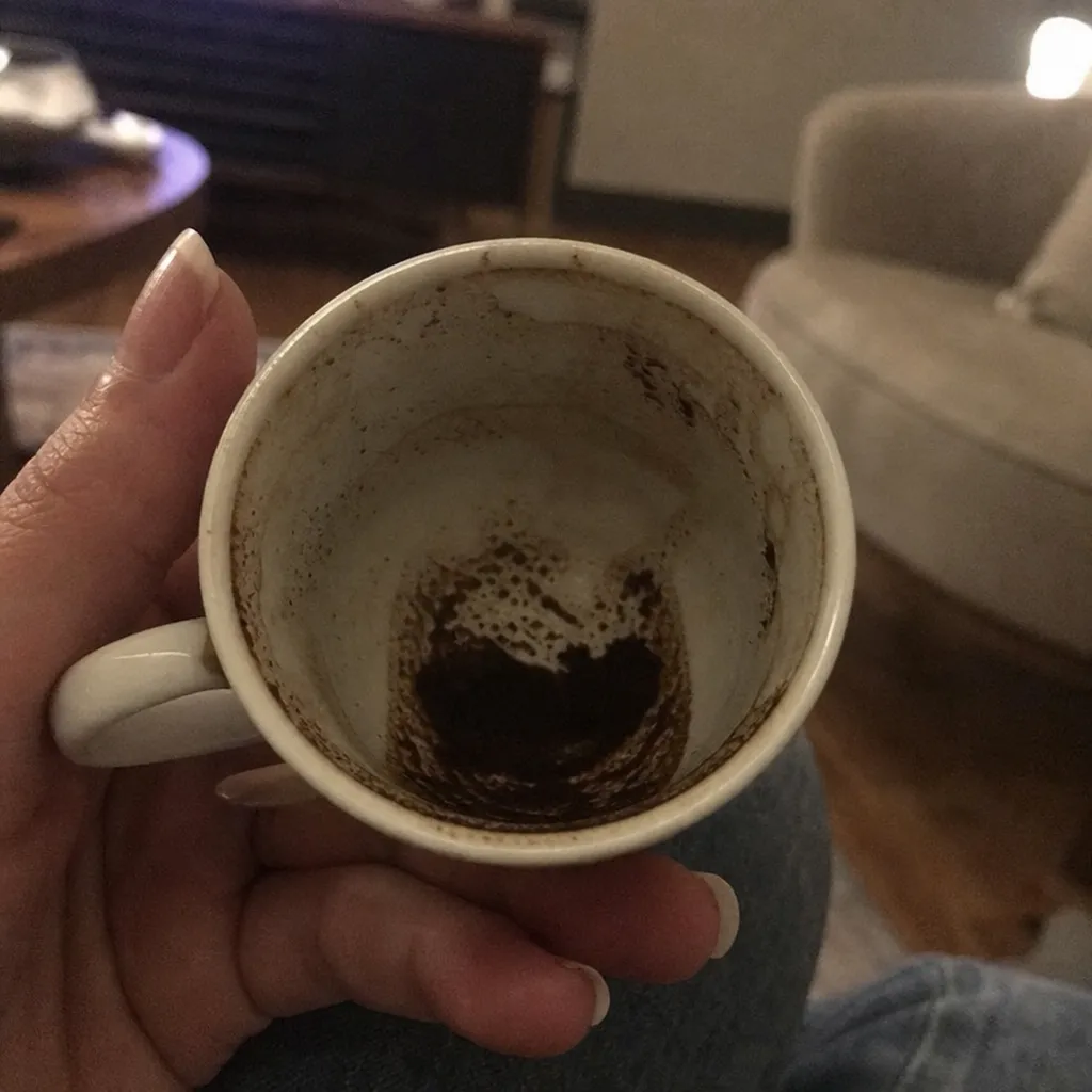 A Turkish coffee cup with grounds settled into a pattern