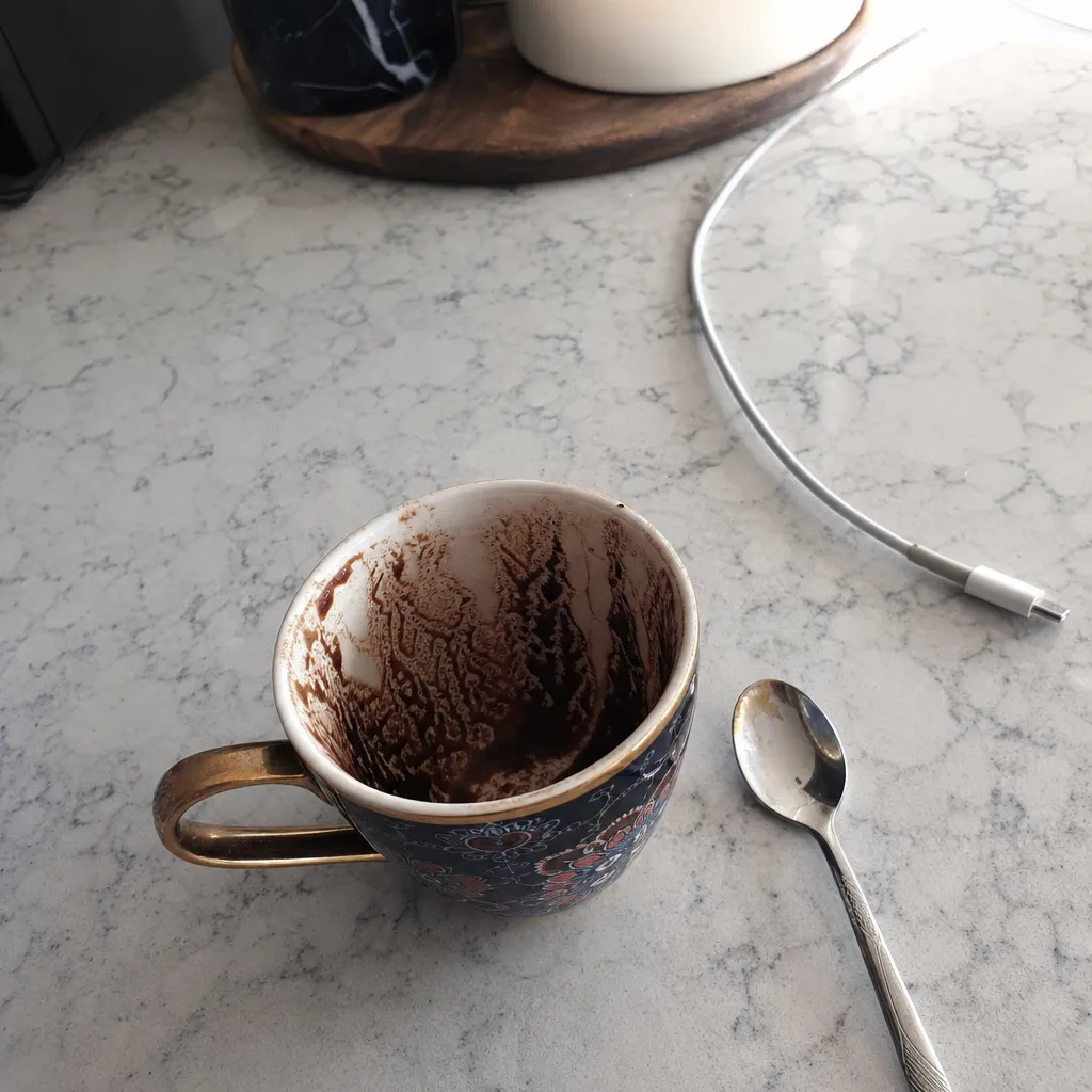 A Turkish coffee cup with grounds settled into a pattern