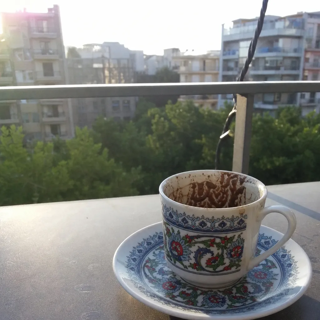 A Turkish coffee cup with grounds settled into a pattern